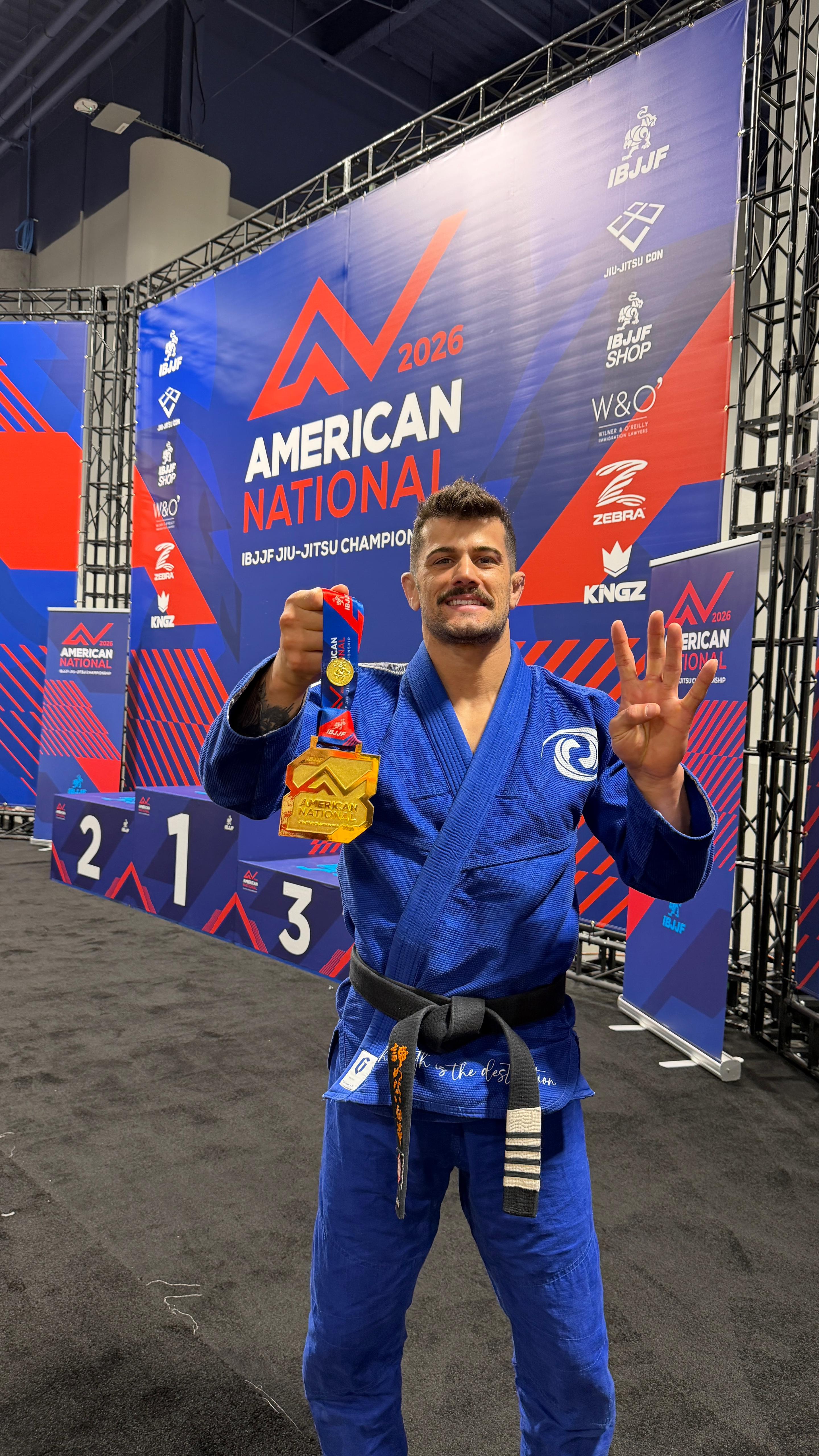 Professor Gabriel Marangoni holding his 4th American Nationals gold medal